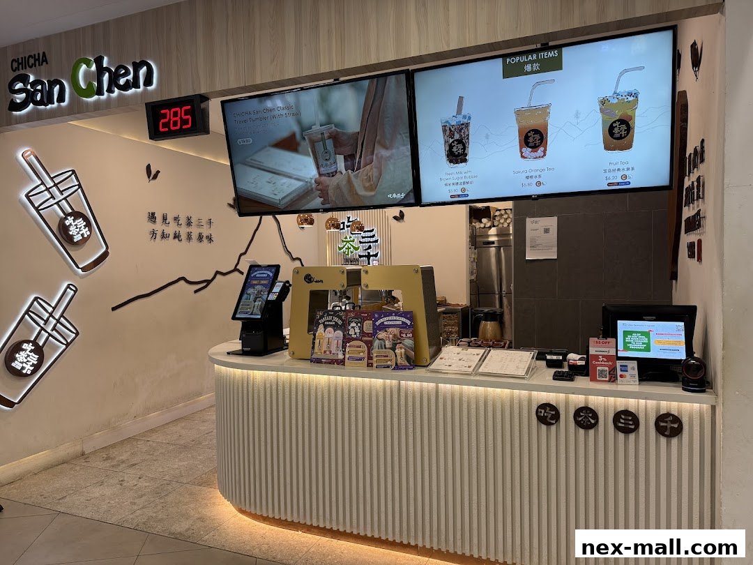 A CHICHA San Chen bubble tea shop counter with popular items displayed on screens.