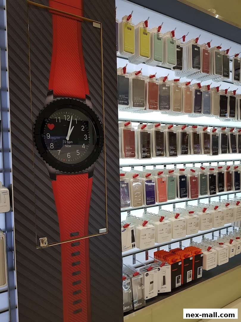A Samsung Experience Store display featuring a large smartwatch and rows of phone cases and accessories.