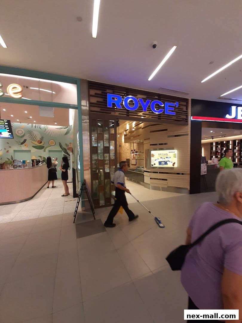 The Royce shop front with blue illuminated signage and a clean interior.