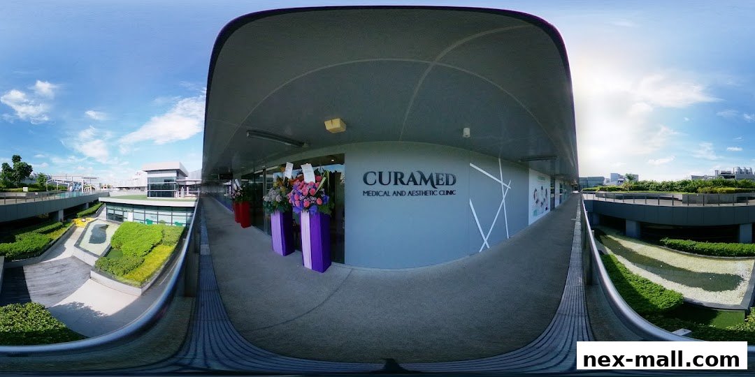 The entrance to CuraMed Medical and Aesthetic Clinic with floral decorations.