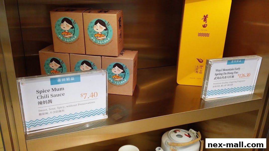 Shelves display packaged chili sauce and tea products from PUTIEN NEX.