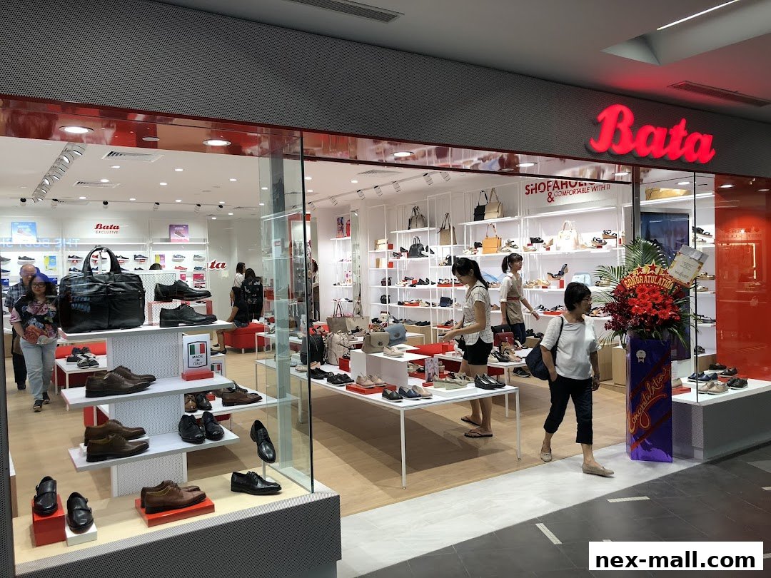 Interior view of a Bata shoe store showcasing various footwear and handbags on display.
