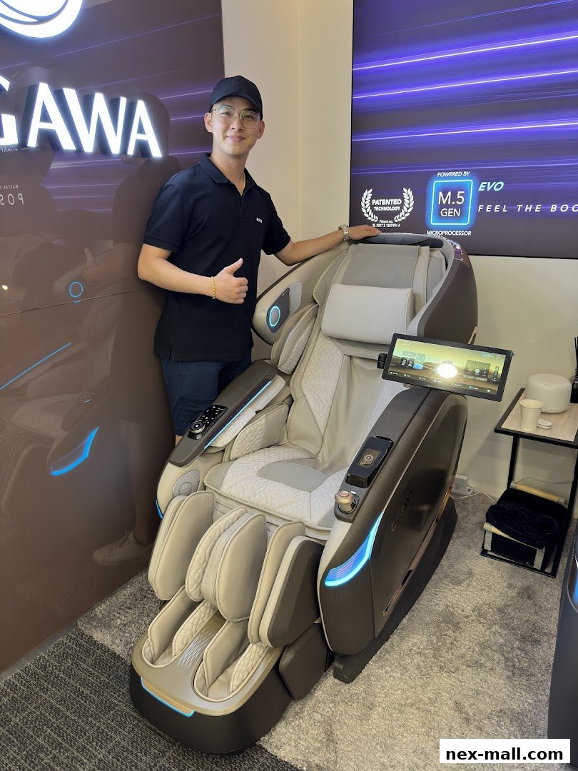 A man gives a thumbs up next to a high-tech massage chair in a store.