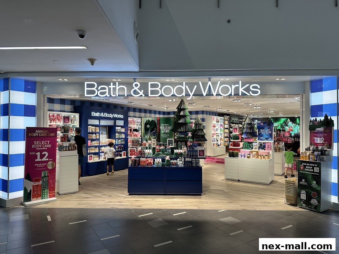 The entrance of a Bath & Body Works store, showcasing various body care products and holiday displays.