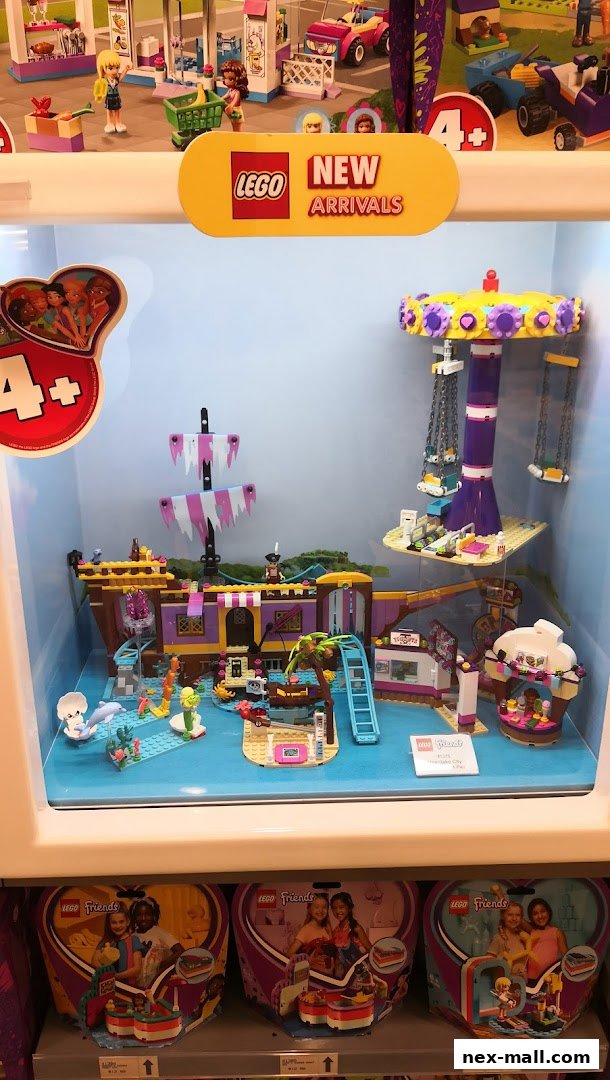 A LEGO Friends display featuring a pirate ship and amusement park rides.