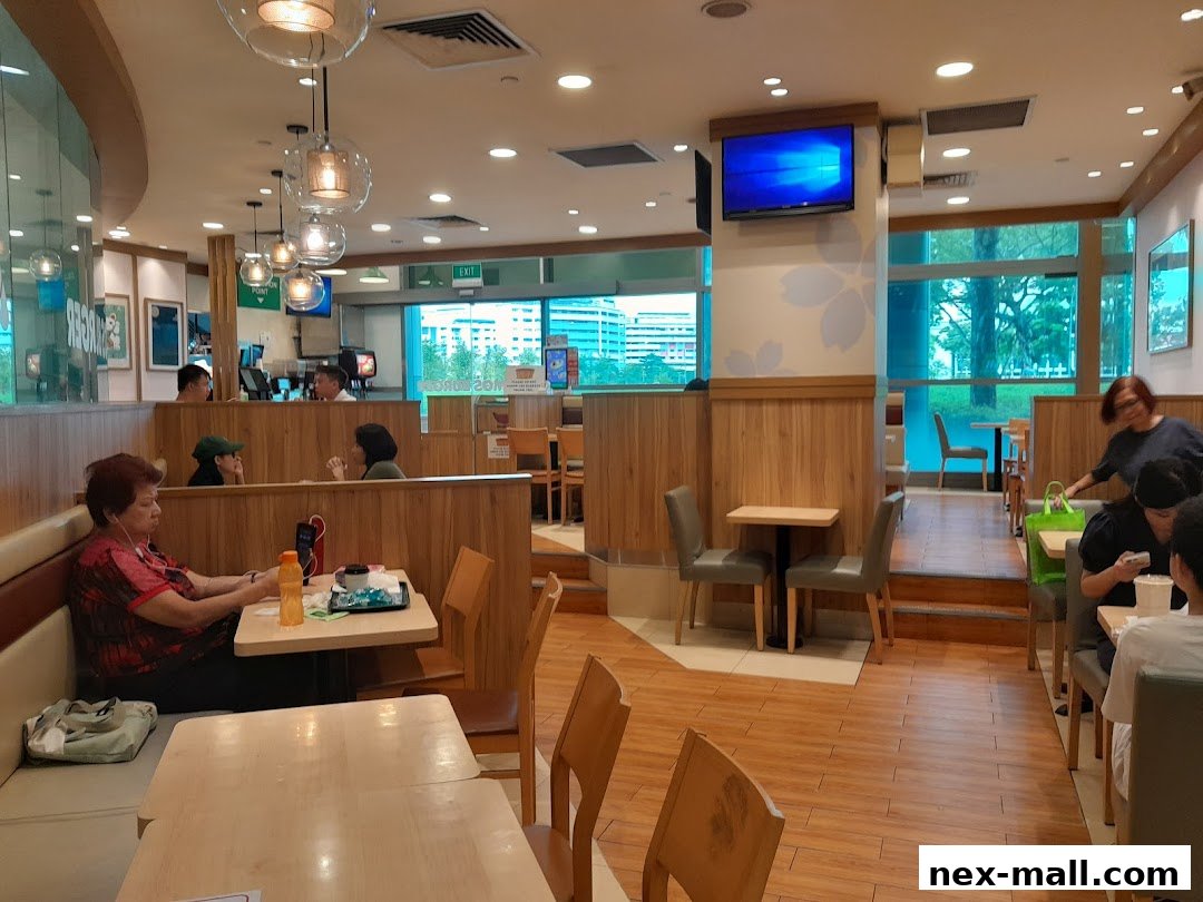 Interior view of a MOS Burger restaurant with customers dining and a modern, clean aesthetic.