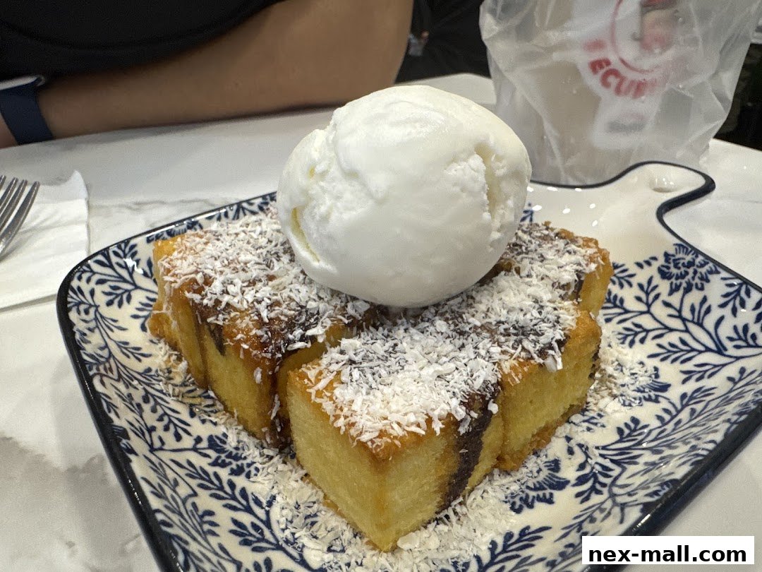 A delicious dessert with ice cream and shredded coconut on a decorative plate.