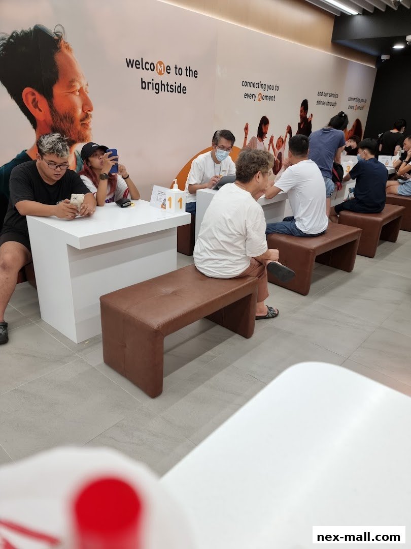 Customers wait at a phone shop with a welcoming interior and branding.