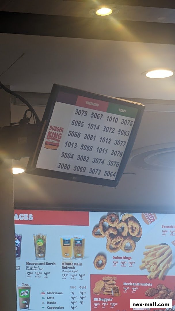 A Burger King menu board displaying order numbers and food items with prices.