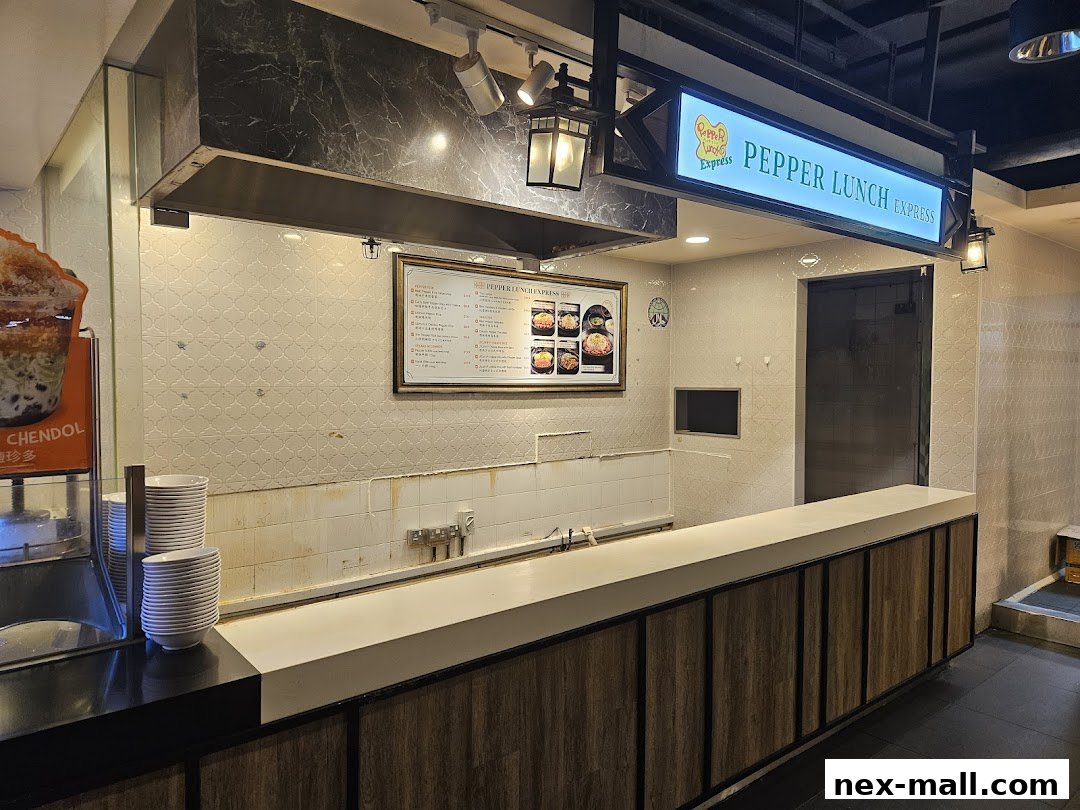 The Pepper Lunch Express counter with a menu and stacks of plates.