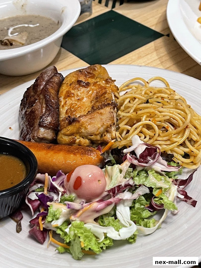 A plate of food featuring steak, chicken, sausage, spaghetti, salad, and a side of gravy.