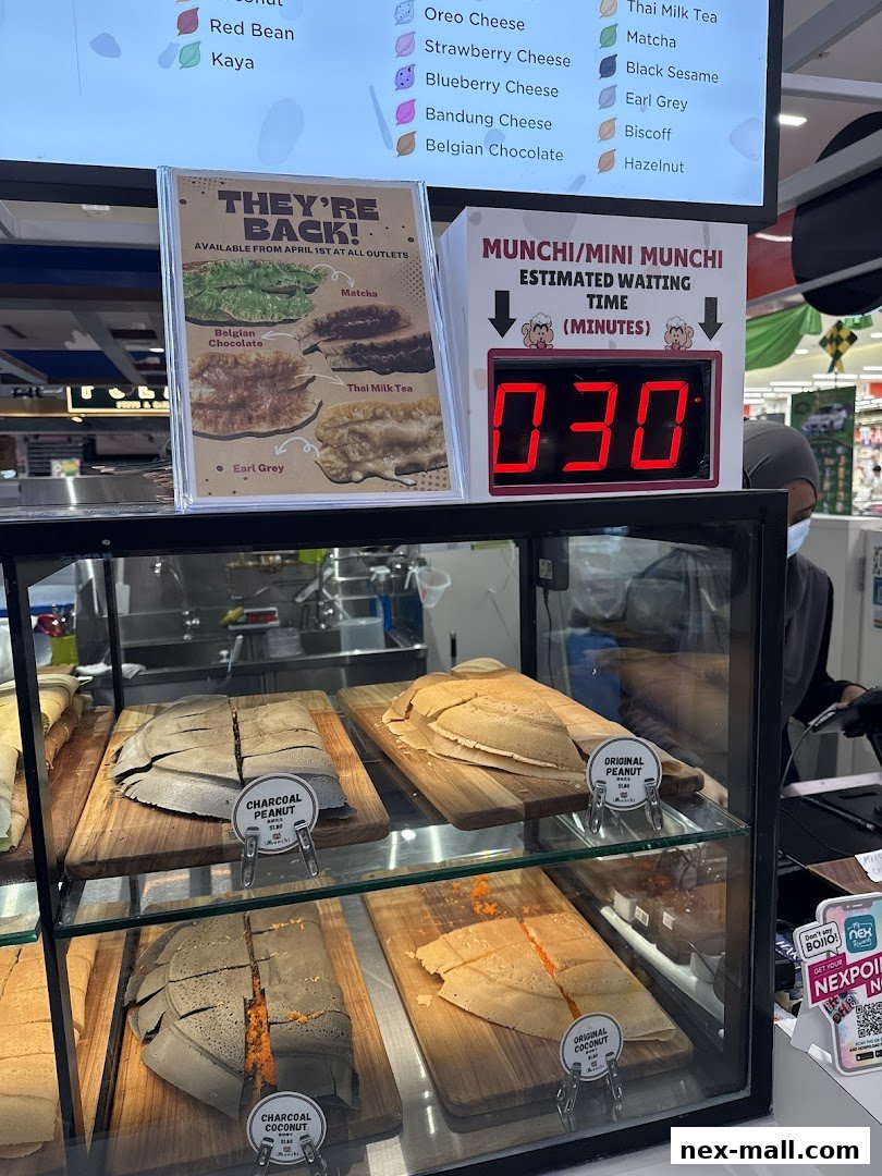 A display of freshly made pancakes with various flavors and an estimated waiting time sign.