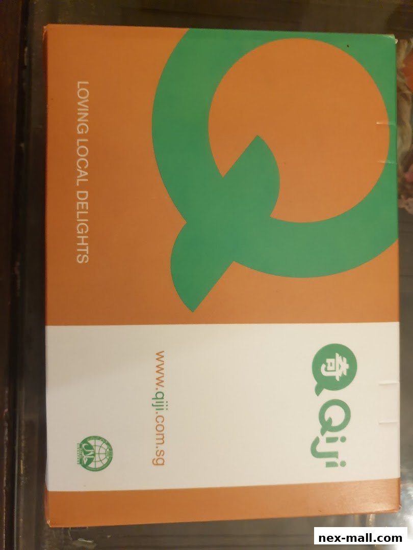 A box with the Qi Ji logo and website address, featuring the slogan 'Loving Local Delights'.