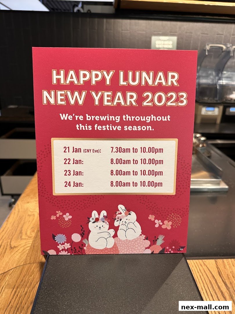 A sign announcing Starbucks' Lunar New Year 2023 operating hours with festive bunny illustrations.