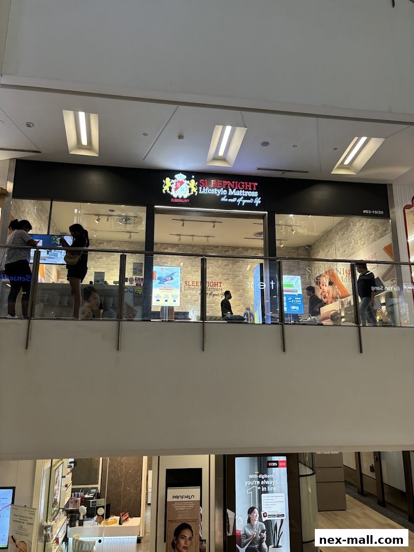 The SLEEPNIGHT Lifestyle Mattress store front with customers browsing inside.
