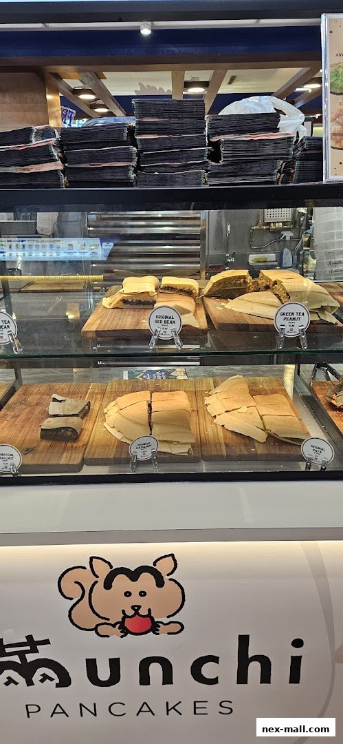 A display case filled with various flavors of pancakes at Munchi Pancakes.