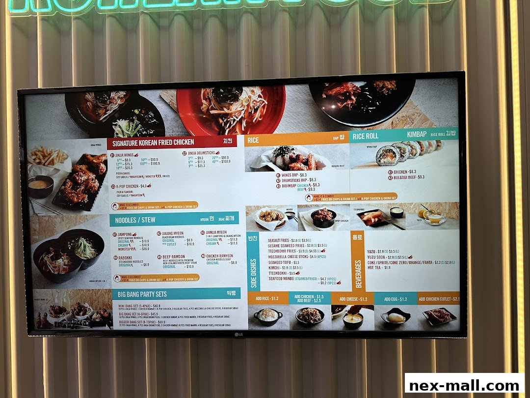 A digital menu board displaying Korean fried chicken, noodles, rice dishes, and beverages.