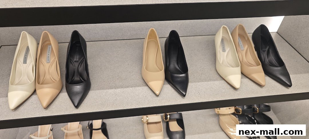 A display of various women's high-heeled shoes in neutral colors on shelves.