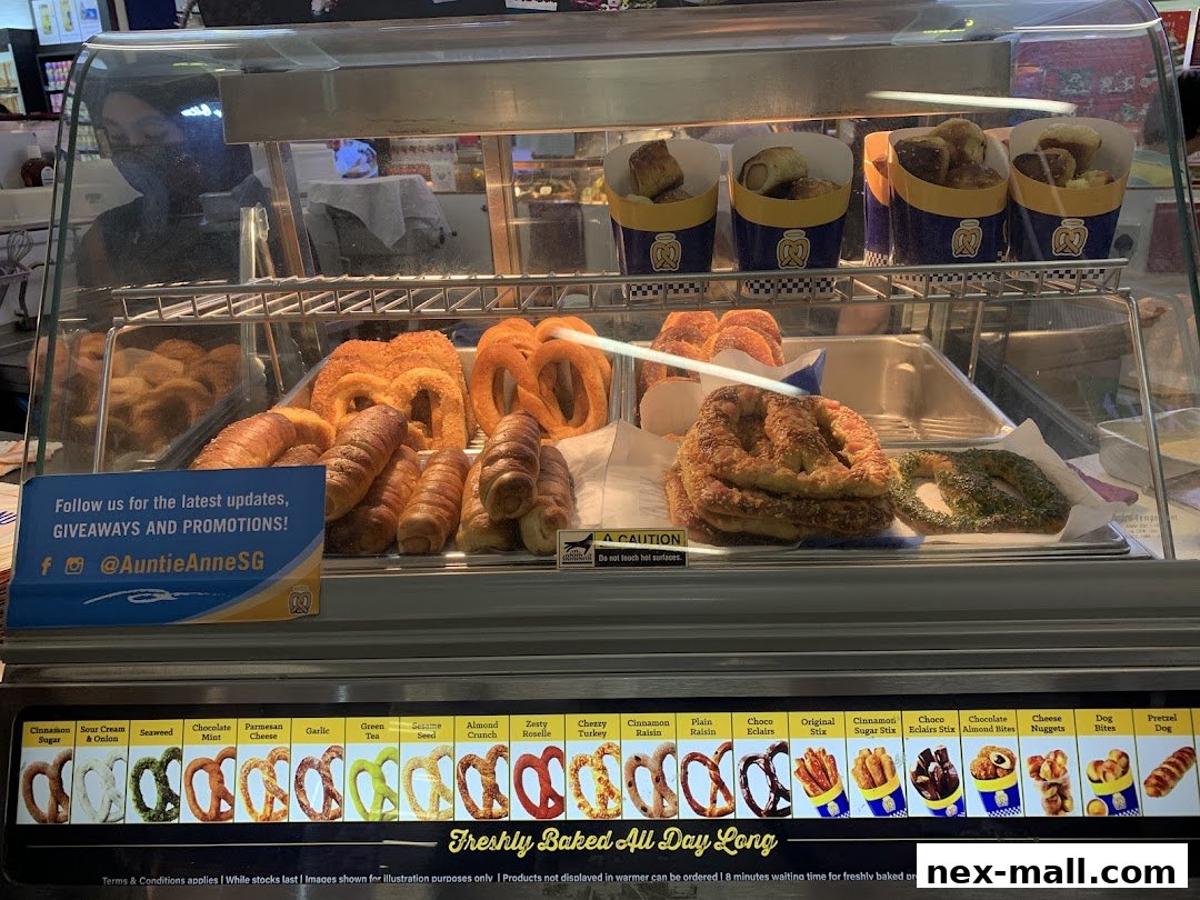 A display case filled with various freshly baked pretzels and pretzel bites from Auntie Anne's.