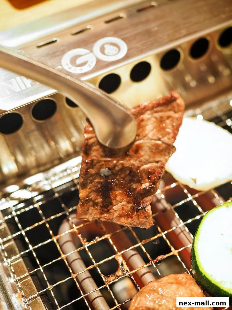A piece of meat is being grilled on a metal grate with tongs.