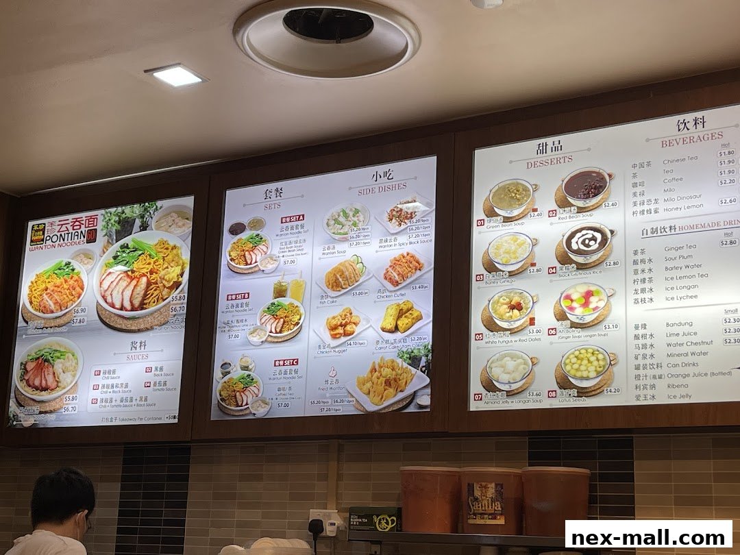 A brightly lit menu board displaying various noodle sets, side dishes, desserts, and beverages.
