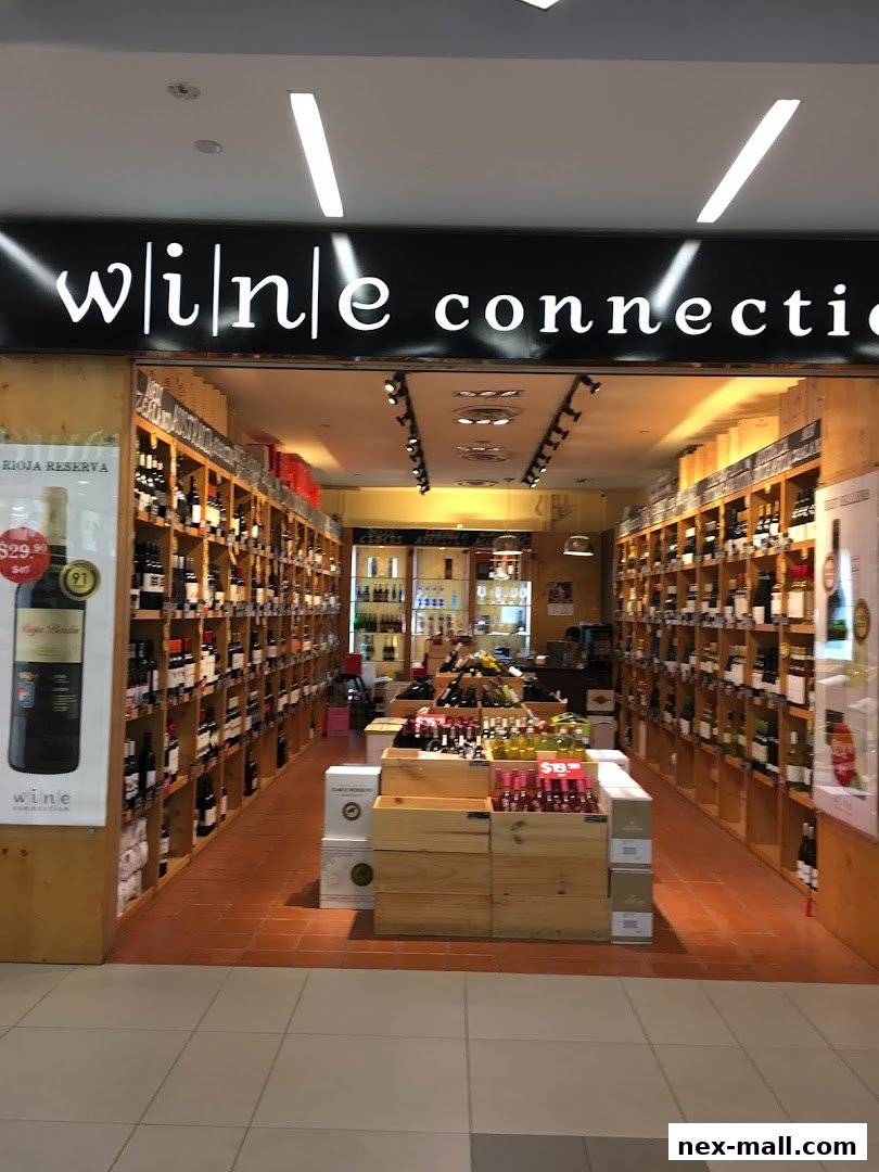The entrance to Wine Connection NEX, showcasing a wide selection of wines on shelves and displays.