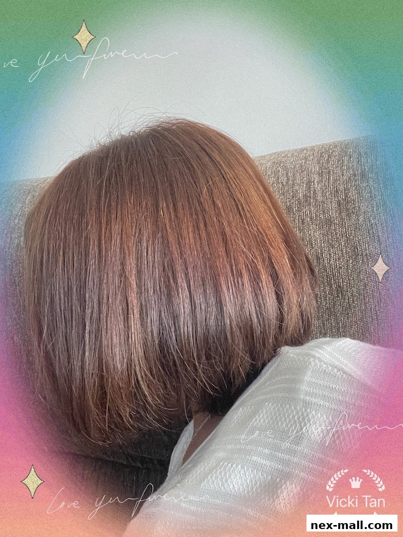 A person with short, reddish-brown hair is resting on a couch, with a colorful gradient background.