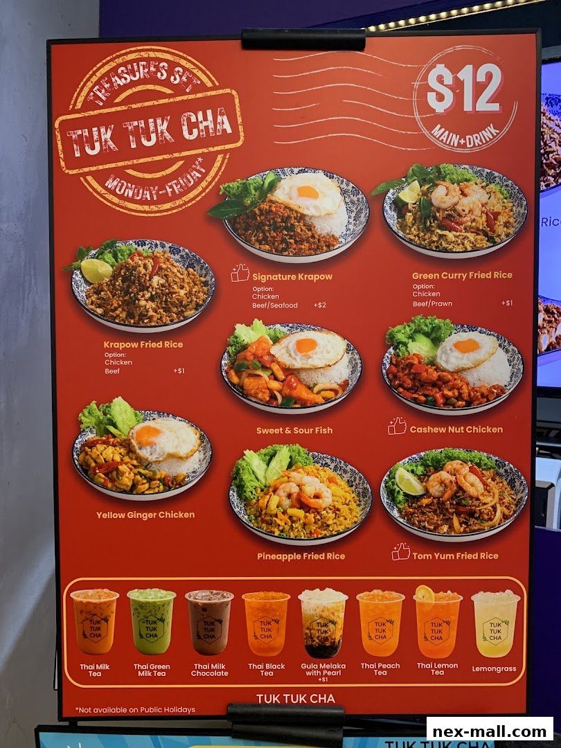 A menu board for Tuk Tuk Cha Treasures featuring Thai dishes and drinks.