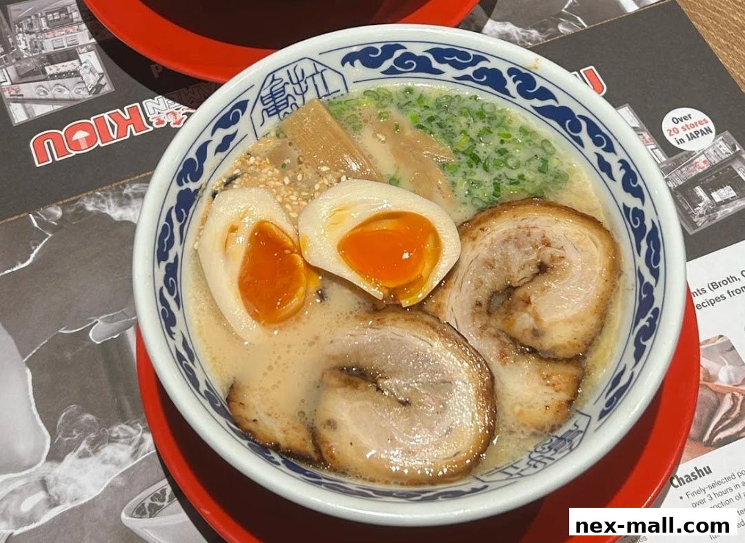 A close-up of a delicious bowl of ramen with chashu pork and a soft-boiled egg.