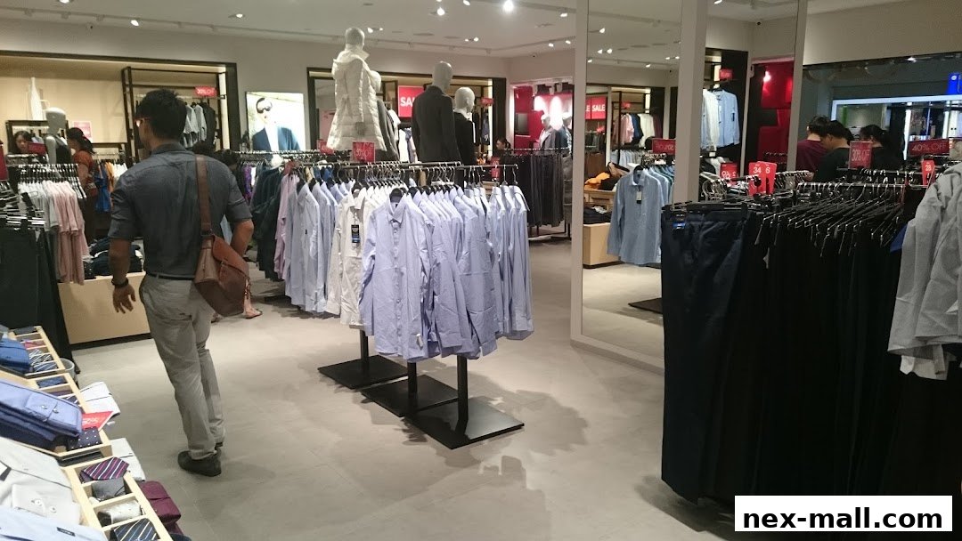Interior view of a G2000 clothing store with racks of shirts and pants.