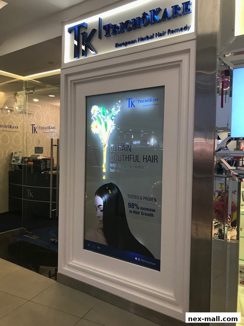 The exterior of TK TrichoKare, a hair loss and scalp treatment center, with a prominent advertisement.