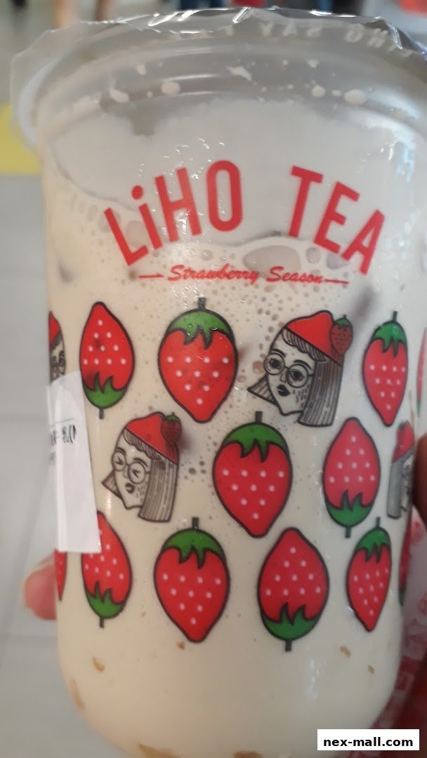 A close-up of a LiHO TEA drink with strawberry-themed packaging.