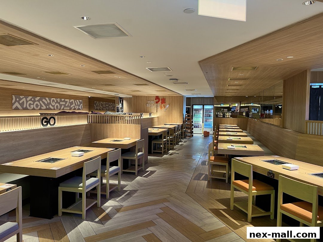 Interior view of a modern Yakiniku restaurant with clean wooden tables and chairs.