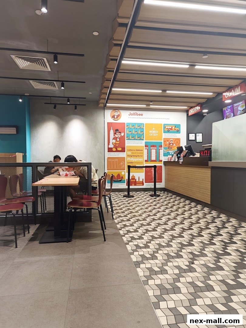 Interior view of a Jollibee restaurant with seating and a counter area.