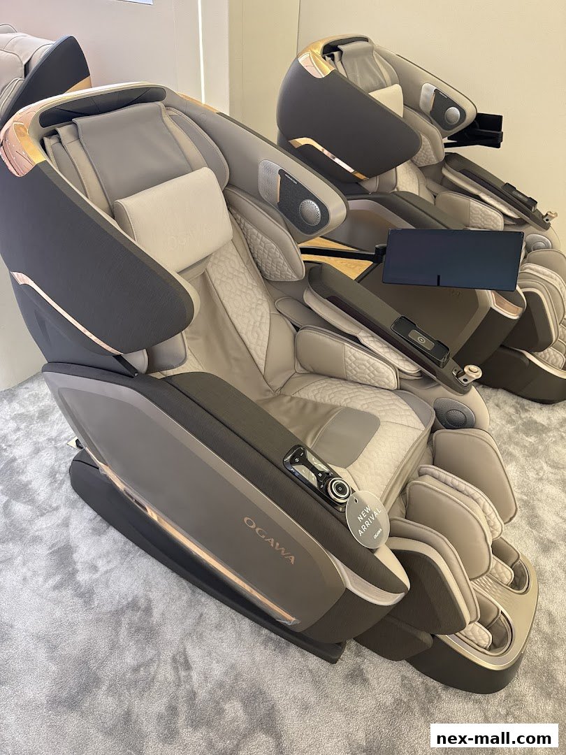 Two luxurious OGAWA massage chairs are displayed on a plush carpeted floor.