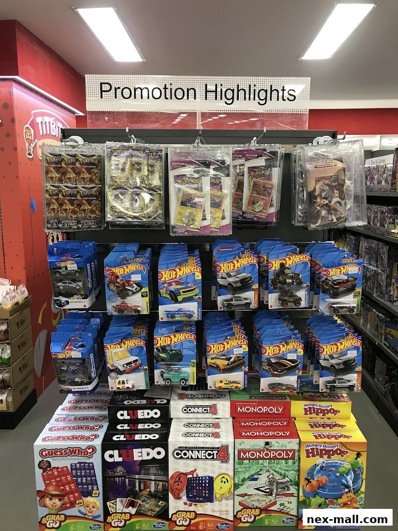 A display of popular board games and trading cards, including Pokemon and Hot Wheels.