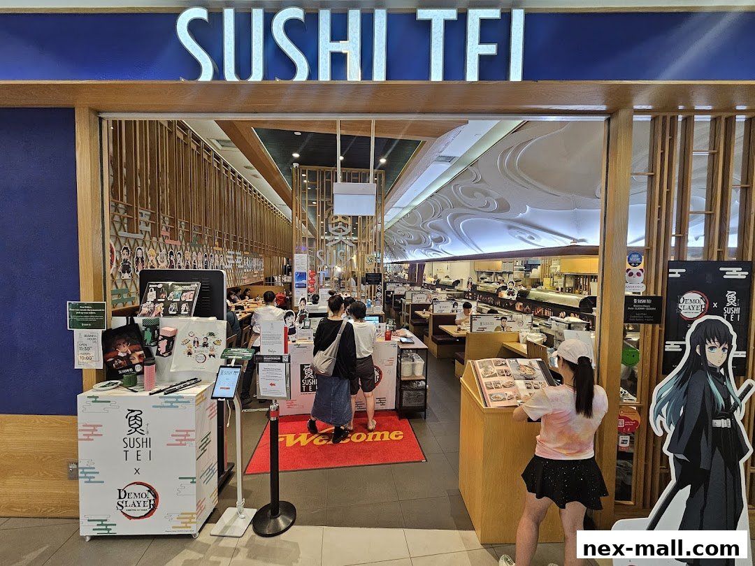 The entrance of Sushi Tei restaurant, featuring its signage and interior view.