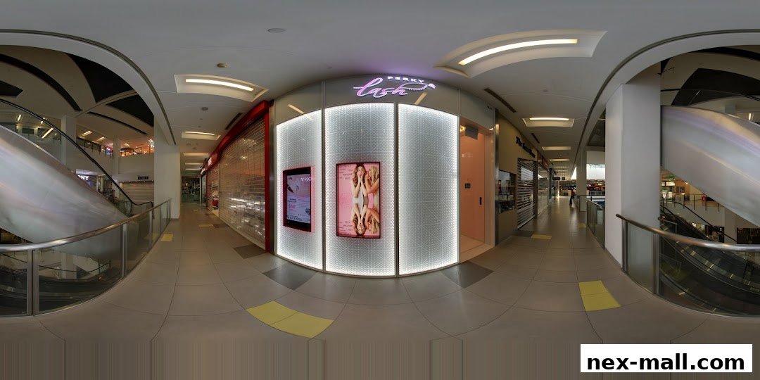 The Perky Lash shop front with illuminated signage and promotional displays in a mall.