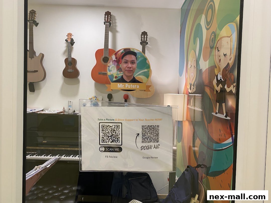 Aureus Academy shop window displays guitars, a piano, and a teacher's photo with QR codes.