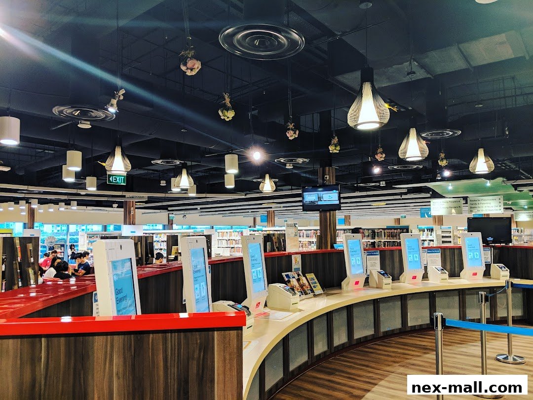 Interior view of a modern library with self-checkout kiosks and bookshelves.