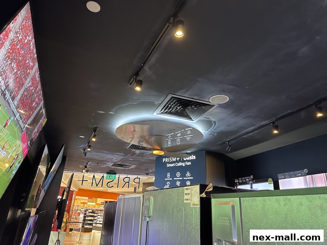 Interior view of a modern electronics store with TVs and appliances on display.