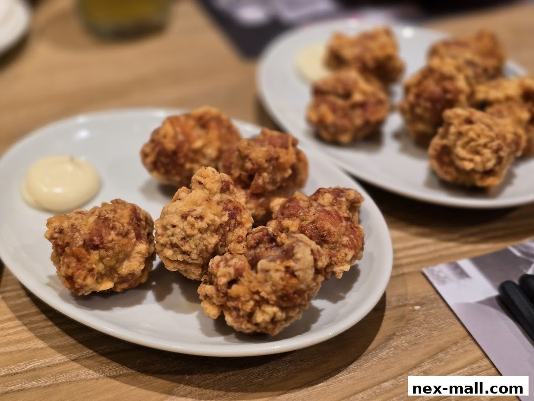 Crispy Japanese fried chicken (karaage) served with a side of mayonnaise on white plates.