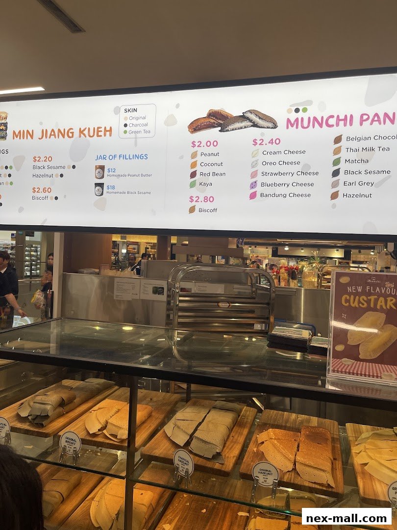A menu board displaying various pancake flavors and fillings, with a display of pancakes below.