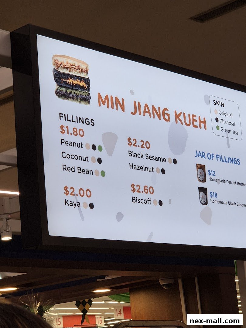 A digital menu board displaying various fillings and prices for Min Jiang Kueh.