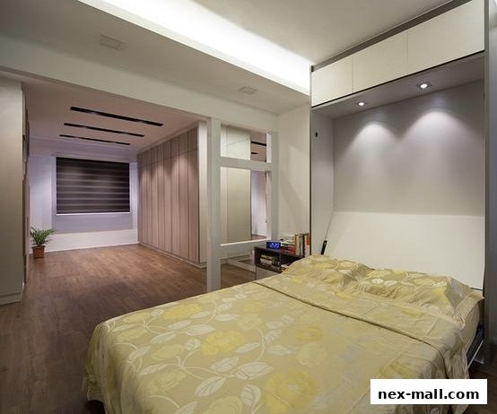 A modern bedroom with a Murphy bed, built-in wardrobes, and a stylish interior.