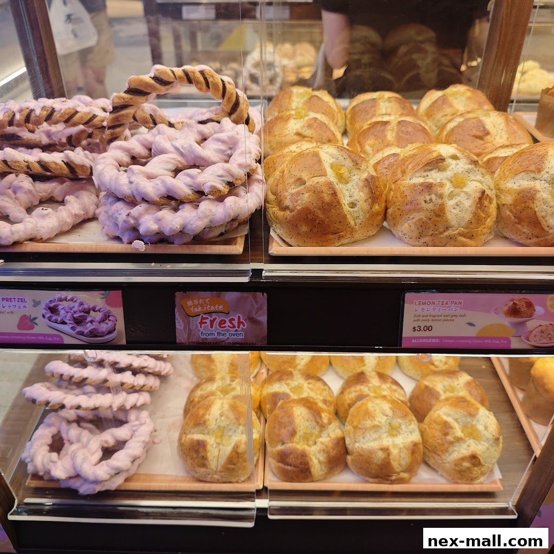 Display case filled with freshly baked Japanese pretzels and lemon tea buns.