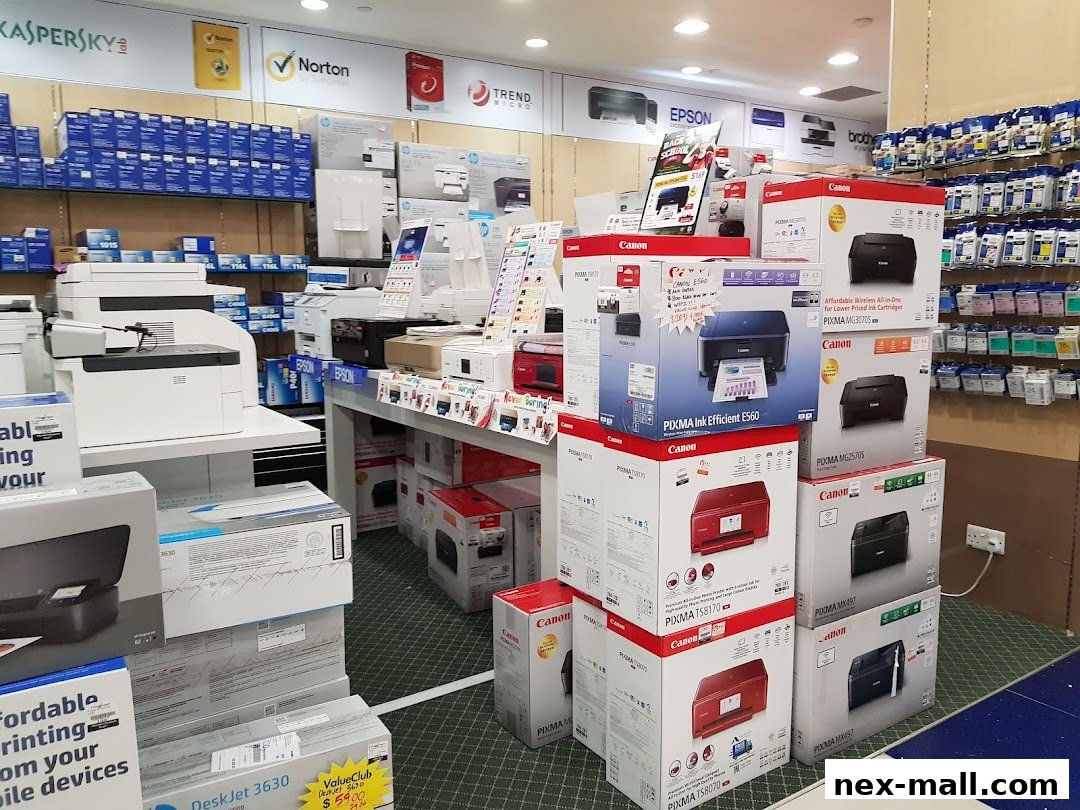 Interior view of a Challenger NEX store showcasing various printers and ink cartridges.