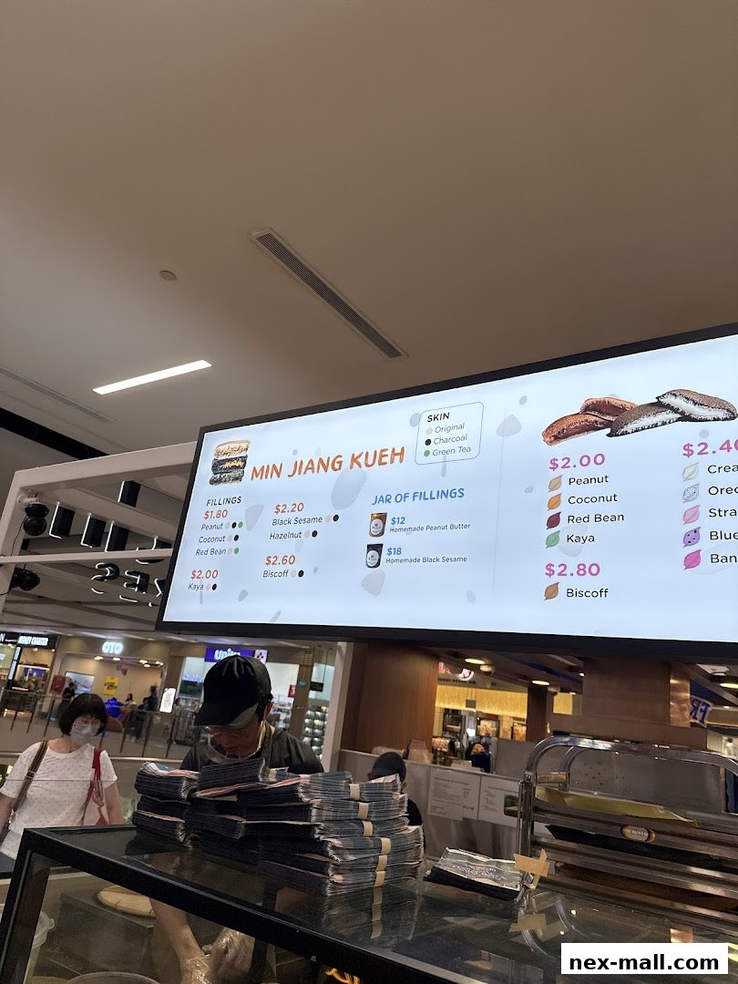 A menu board displaying various fillings and prices for Min Jiang Kueh.