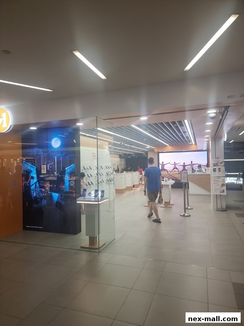 The entrance of a modern M1 NEX phone shop and internet service provider.