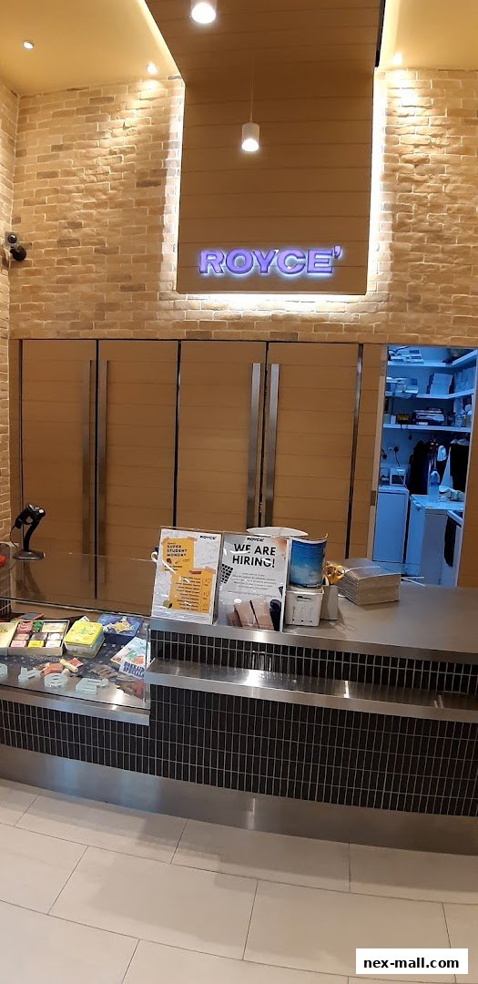 The Royce shop counter displays various products and a 'We Are Hiring!' sign.